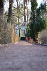 Gravel path leading into perspective to a stone gazebo in the park