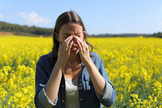 Allergic woman scratching itchy eyes in spring season