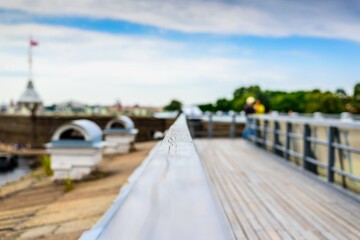 Summer in the city, a walking terrace with panoramic views of the city and walking people. Close up view from the handrail on the sidewalk level