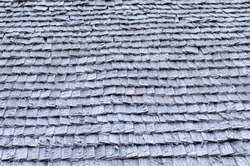 Grey background, pattern or texture of wood or bark roof tile or shingles of old house, hut or cottage
