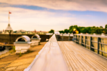 Summer in the city, a walking terrace with panoramic views of the city and walking people. Close up view from the handrail on the sidewalk level