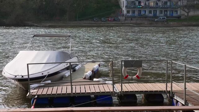 A docked personal water craft on the port in Weser River, Hameln, Germany in $K