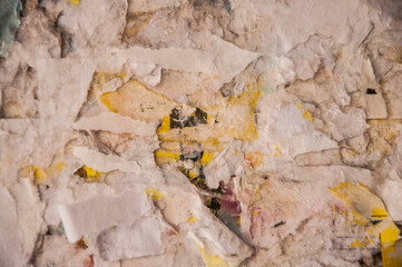 Torn glued paper flyer texture on timeworn urban wall