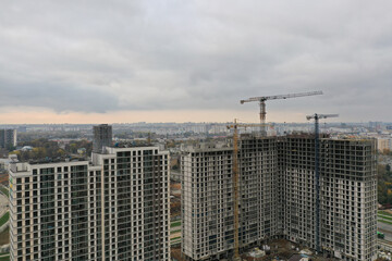 Panorama of new multi storey buildings near cranes
