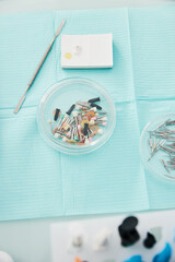 Prophy cups tray, dental spatula and cement lying on table