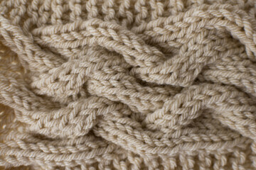 knitting background backdrop of cable stitch design with beige yarn 