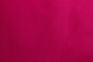 Texture of magenta cotton fabric, background or backdrop. Clothing, sewing, gressmaking, haberdashery. Copy space.