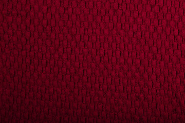 Knit burgundy fabric texture, background or backdrop. Textile, scarf or sweater textured surface. Warm accessories, clothing, fashion concept.