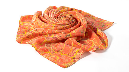 Bright orange  silk fabric folded in a shape of the flower on a white background. Isolated decoration.