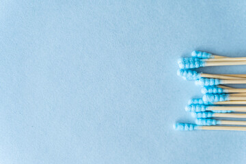 Eco friendly composition of bamboo cotton swabs on blue background, copy space. Sustainable lifestyle concept, zero waste, plastic free.