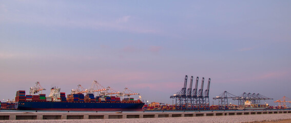 Naklejka premium Logistics and container loading by large barges by sea in a harbor full of containers waiting to be transported