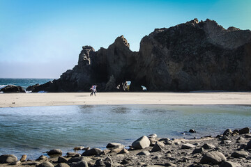 Couple walking on the beautiful and mountainous Big Sur Coast of California, United States of America aka USA.