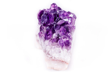 Macro mineral stone purple amethyst in crystals on a white background