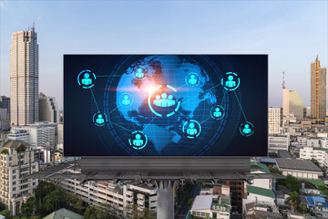 World planet Earth map hologram and social media icons on billboard over panorama city view of Bangkok, Southeast Asia. The concept of people networking and connections.