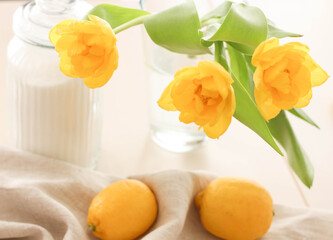 Yellow lemons, sugar and yellow tulips on the table. Conceptual Spring photo. Kitchen Photos. Interior.Vitamins 