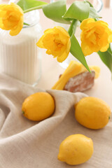 Yellow lemons, sugar and yellow tulips on the table. Conceptual Spring photo. Kitchen Photos. Interior.Vitamins 