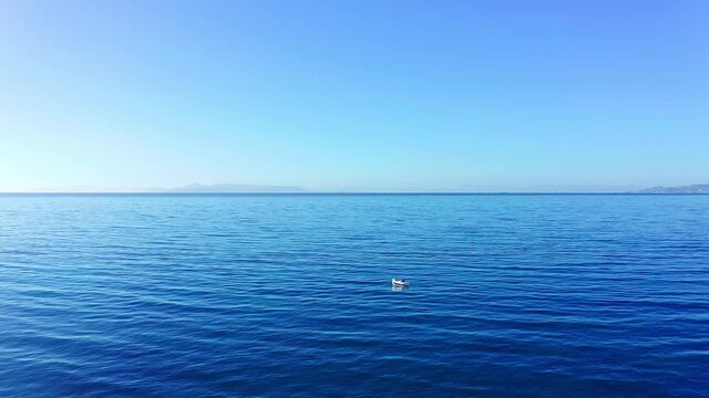 A small boat on the vast sea near Diakopto in Greece 