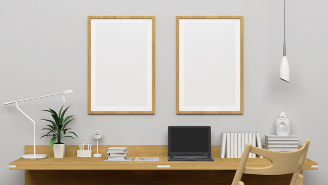 Two vertical frames mockup on the empty white wall with modern work desk interior.