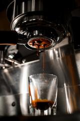 making espresso on coffee machine through portafilter from arabica coffee