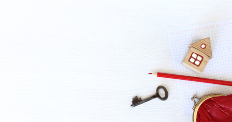 house and key with red pencil and wallet on the table with a sheet of paper top view. payment for...