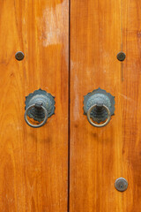 Chinese bronze handle on brown door. Oriental background