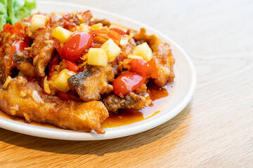 fried grouper fish topped with sweet ,sour and hot sauce