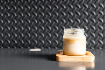 A glass of espresso shot over cold fresh milk create gradient layer called dirty coffee