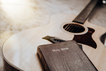Bible on acoustic guitar with carpet