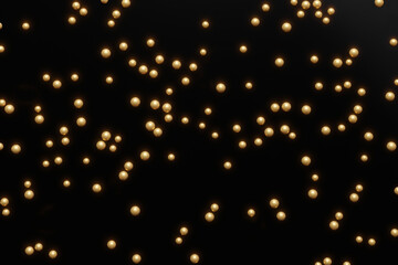 3d render of gold shiny pearles on a black background