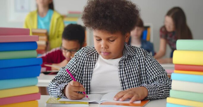 African kid enjoying learning to draw at middle school