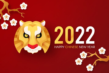 Happy Chinese New Year, 2022 the year of the Tiger. Papercut design with tiger head character, cherry blossom and flowers. Chinese text means The year of the Tiger.