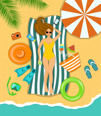 Woman sunbathing on a beach under the tropical palms with accessories for beach 