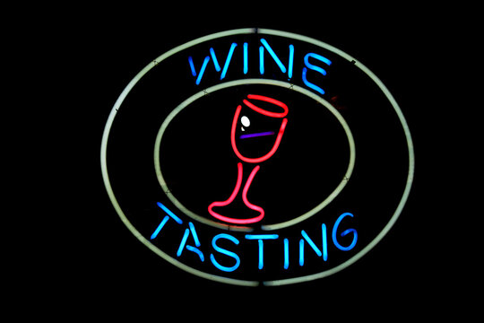 Neon Wine Tasting sign on black background