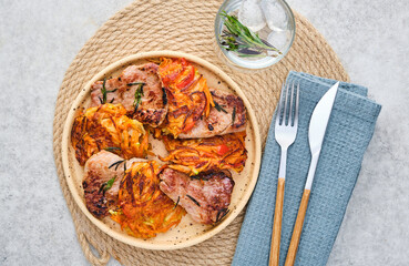Roasted veal with rosemary and vegetable garnish. Top view.