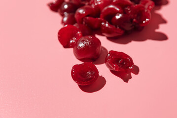 ripe peeled pitted cherries. pink background