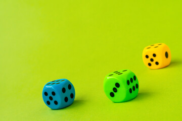 Three colored dice on green background