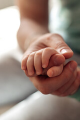 Baby's palm in the father's hand.Father's Day concept.Paternal care.Newborn care.Close-up,selective focus.