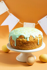Easter cake covered with icing on a cake bowl and Easter eggs. Festive concept.