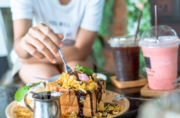 toast bread dessert and customers eating by spoons at the reastaurant.