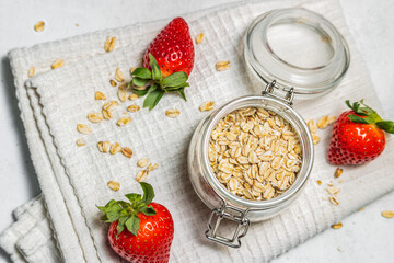 A jar of oatmeal and strawberries. Healthy eating and slimming. Healthy eating habits.