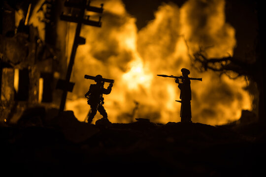 Military soldiers silhouettes with bazooka and rpg. War Concept. Military silhouettes fighting scene on war fog sky background, Mojahed with rpg and us soldier with bazooka at sunset.