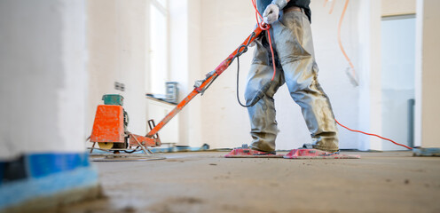 Filling the floor of a renovated apartment with concrete, screed and leveling the floor by...