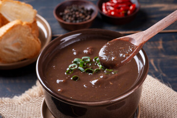 .Delicious dish of Brazilian cuisine called Caldo de Feijão. Made with black beans, bacon and sausage.