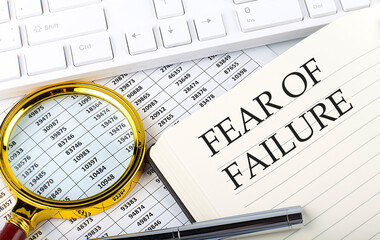 FEAR OF FAILURE text on notebook with chart, magnifier,keyboard and pen