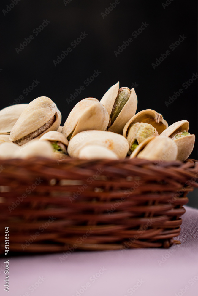 Sticker Closeup shot of fresh pistachios in a straw basket