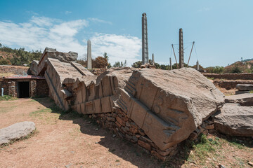 Fototapeta na wymiar Aksumite civilization ruins, Ancient monolith stone obelisks behind Church of Our Lady of Zion, symbol of the Aksum, Ethiopia. UNESCO World Heritage site.