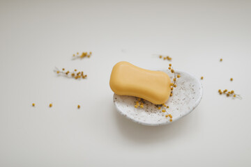 Handmade natural soap on white floral background. Soap making. Soap bars. Spa, skin care. Natural Organic spa cosmetic products on white table from above