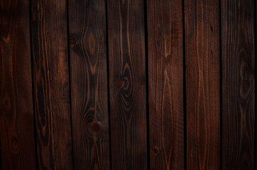 the wall is made of rough-hewn wenge-colored boards