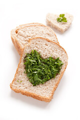 Wheat Bread Slice with cut of hole in the shape of heart and parsley