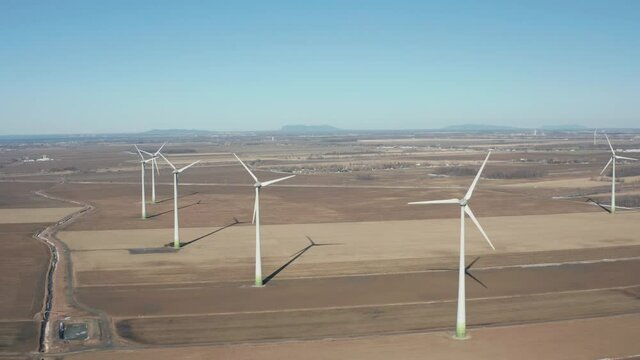drone side move looking back in a wind farm full of turbines